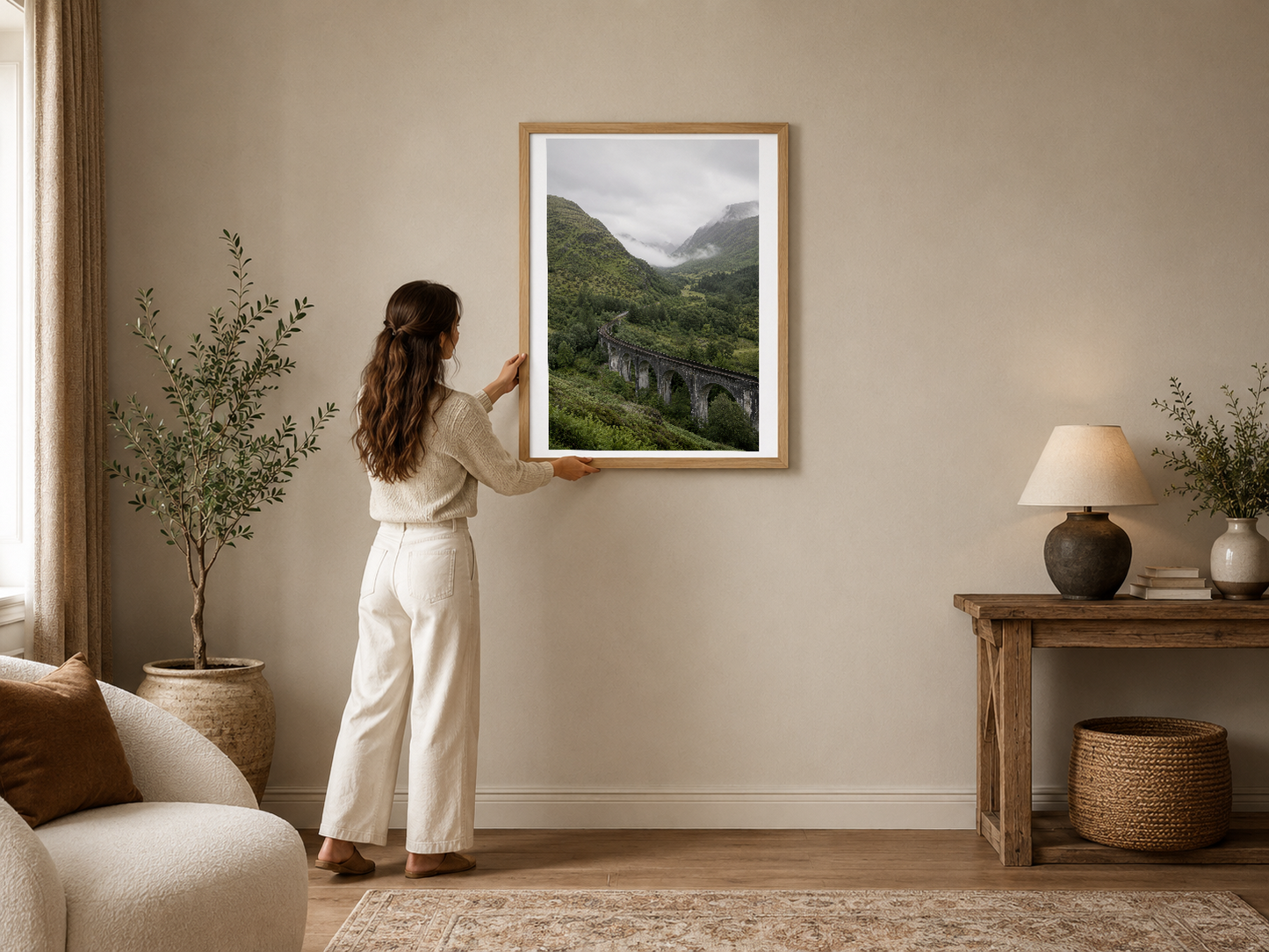Dağlık vadide taş köprü manzarası, ahşap çerçeveli poster sakin modern oturma odasını zenginleştiriyor.