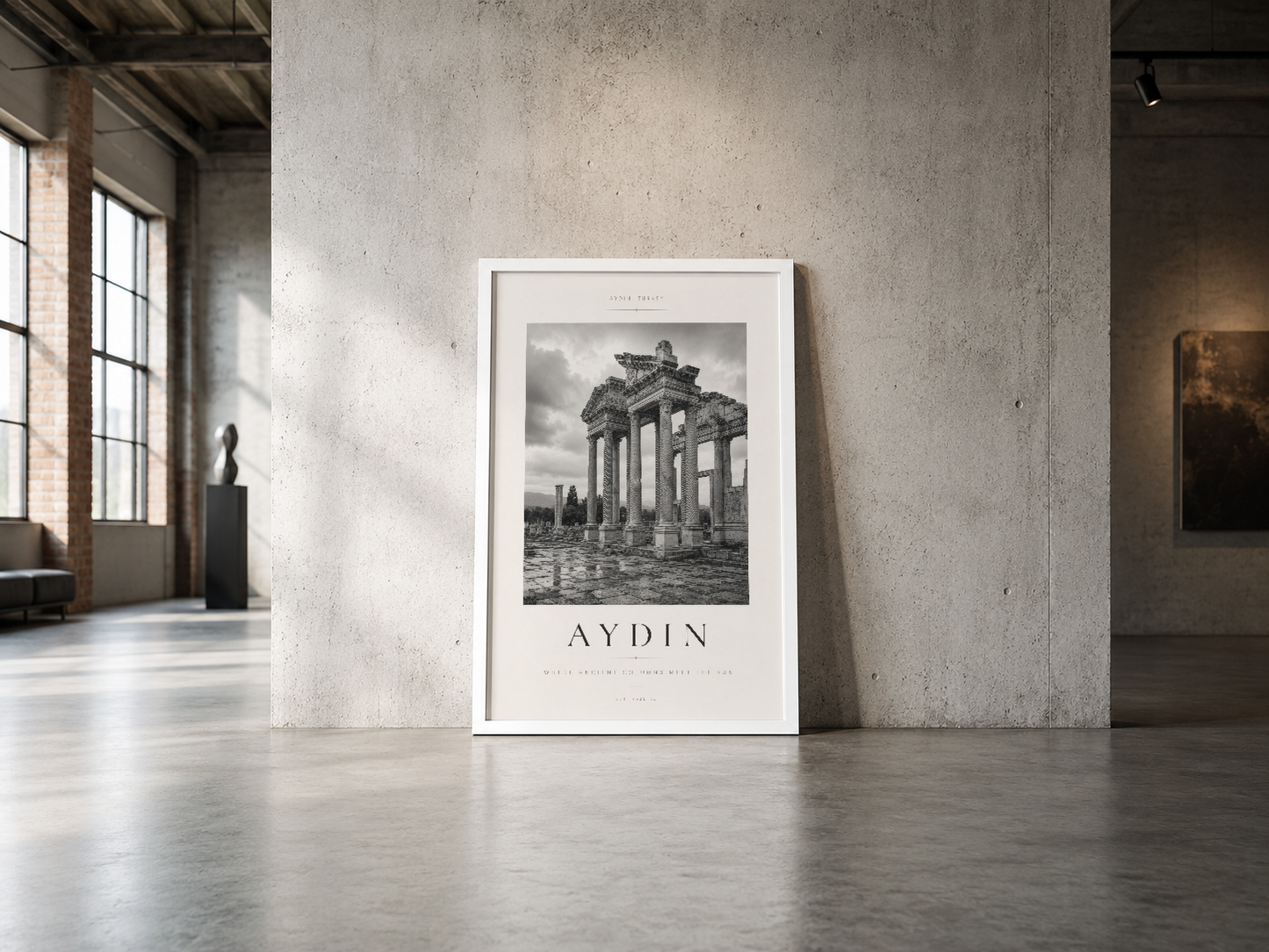 Aydın antik yapıları gösteren beyaz çerçeveli poster, endüstriyel betona karşı görkemli şekilde duran minimalist sanat eseri.