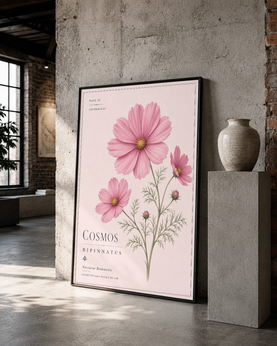 Siyah çerçeveli cosmos tablosu, endüstriyel mekanda botanik sanat eseri olarak sergilenmiş.