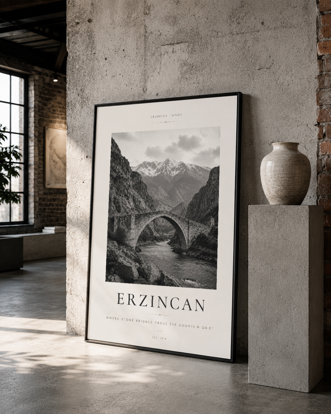 Erzincan doğal manzarası, siyah çerçeveli poster olarak minimalist betonlu iç mekanın merkezinde yer alan duvar tablosu.