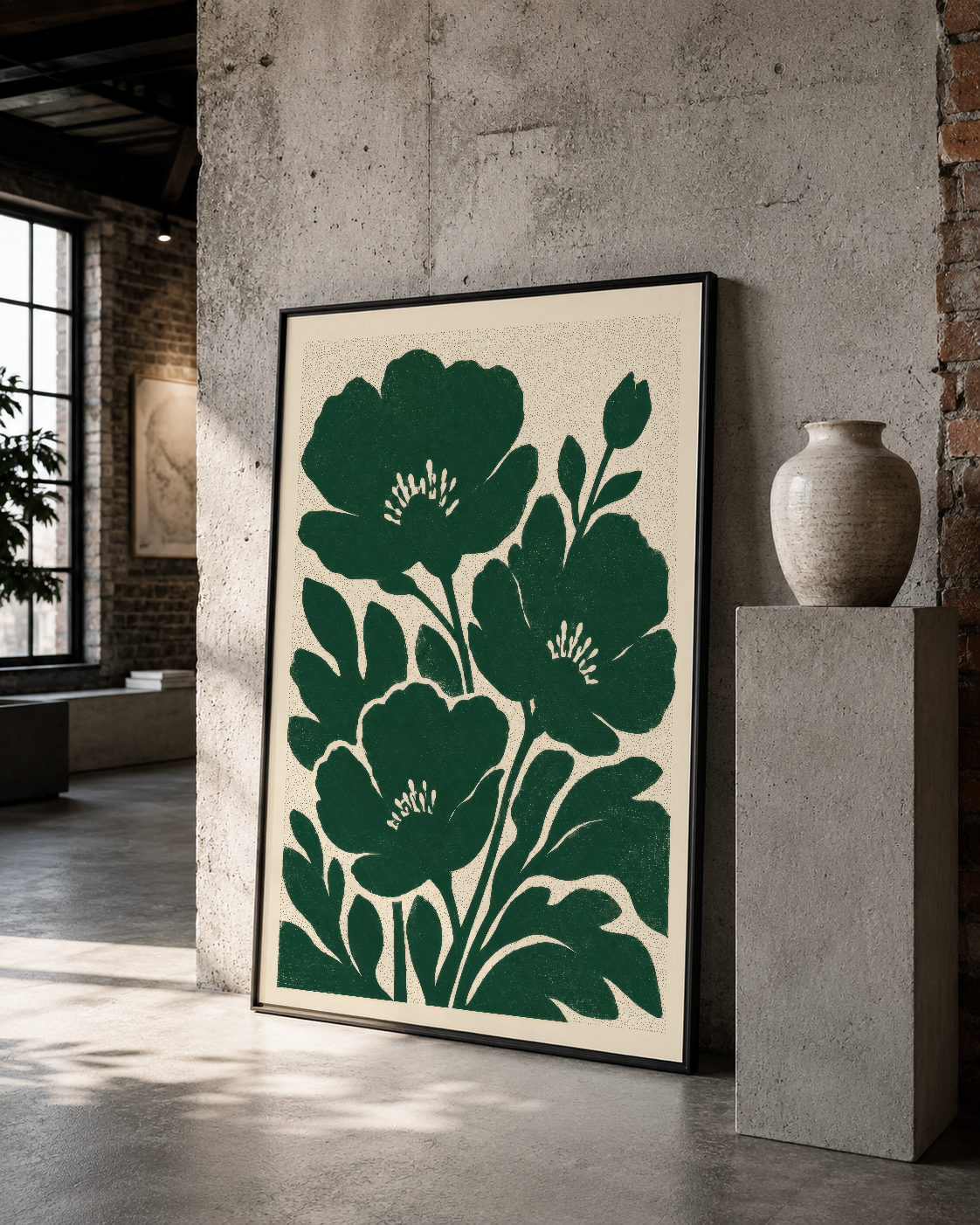 Siyah çerçeveli cesur yeşil botanik tablo, modern industrial alanda çimento duvarına karşı sanat objesi.