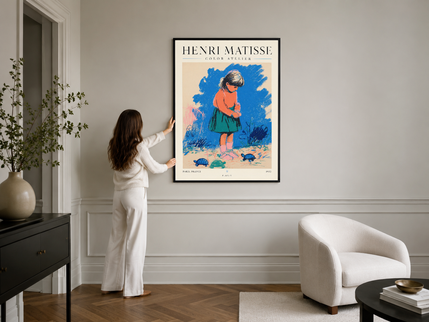Matisse posteri siyah çerçevede, modern beyaz oturma odasının duvar dekorasyonu olarak yer almakta.