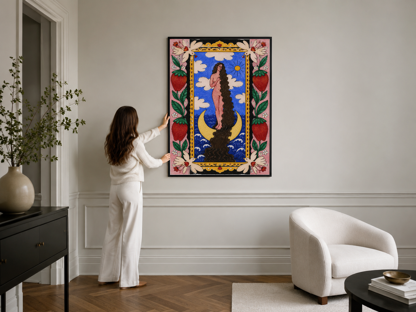Ay ve figür motifli renkli sanat tablosu, pembe çiçek bordürü, gri duvar üzerinde siyah çerçeveli klasik tasarım.
