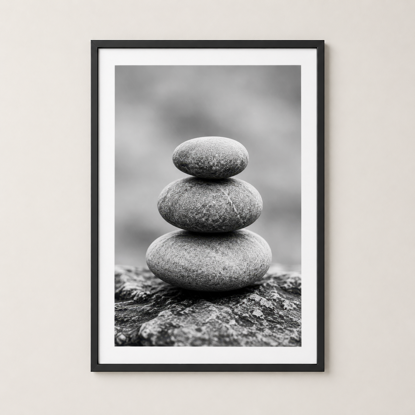 Stacked stone pyramid art print, elegantly framed in sleek black, minimalist aesthetic.