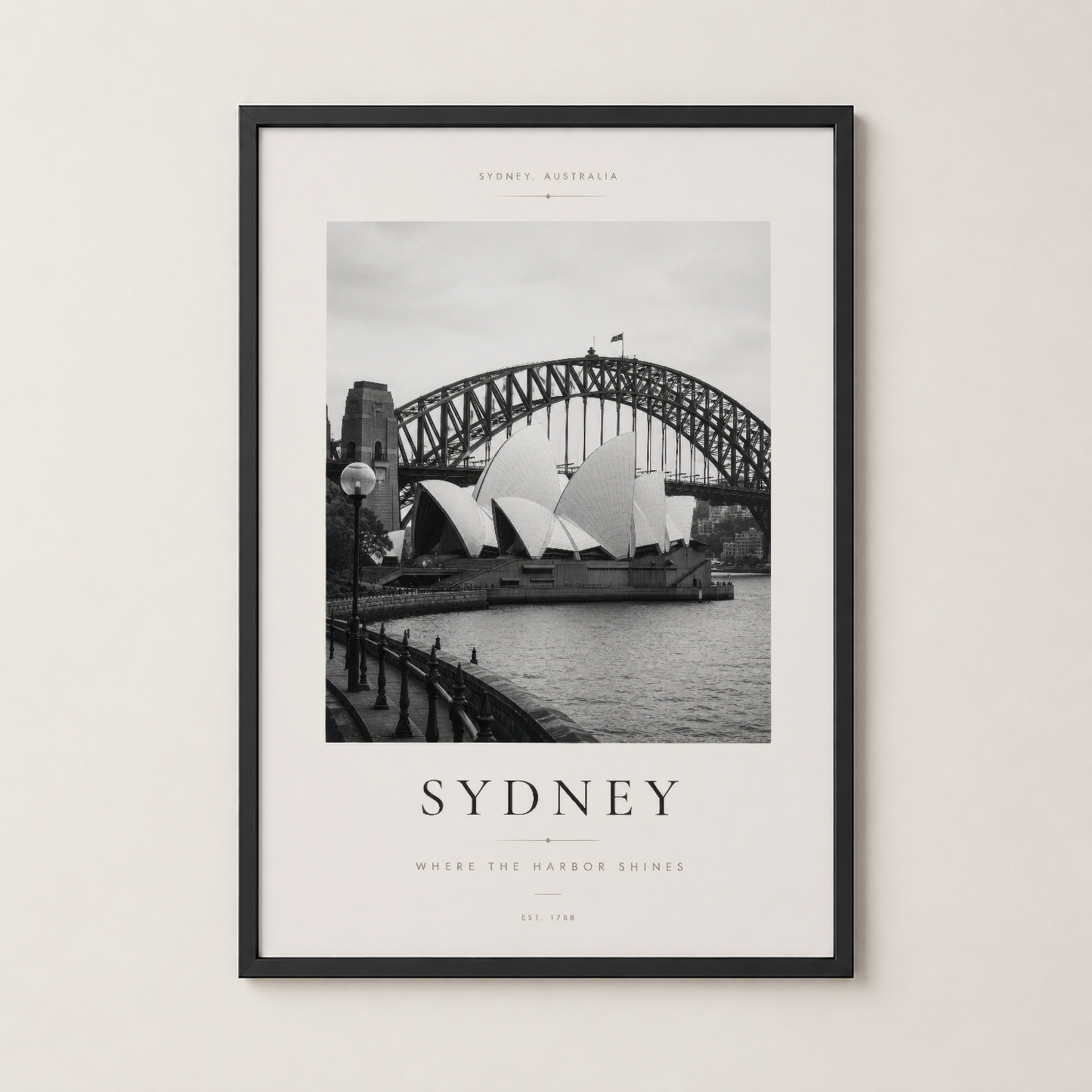 Sydney manzarası tablosu siyah çerçevede, oturma odasının duvarında şık bir dekorasyon parçası olarak sergilenmekte.