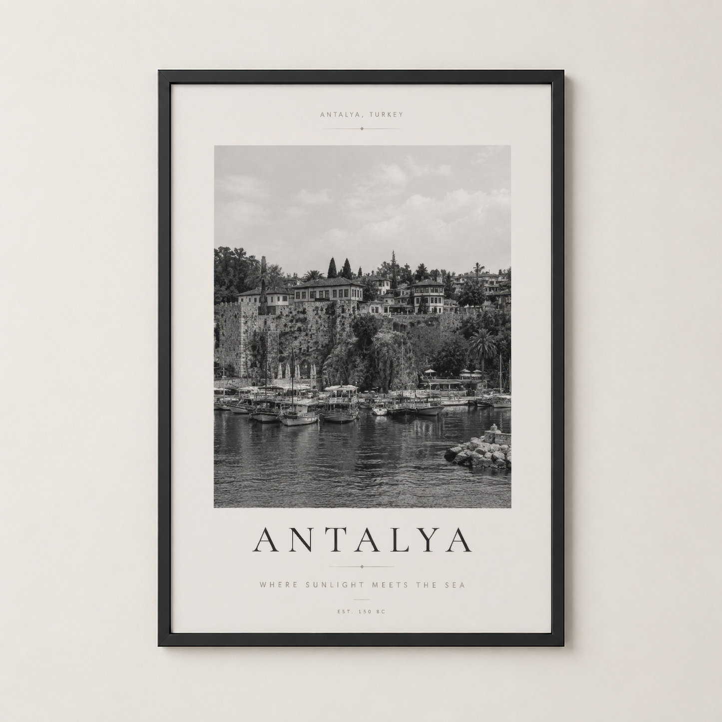 Antalya baskısı siyah çerçevede, deniz manzarası ve antik duvarlarıyla nostalji yüklü bir dekorasyon.