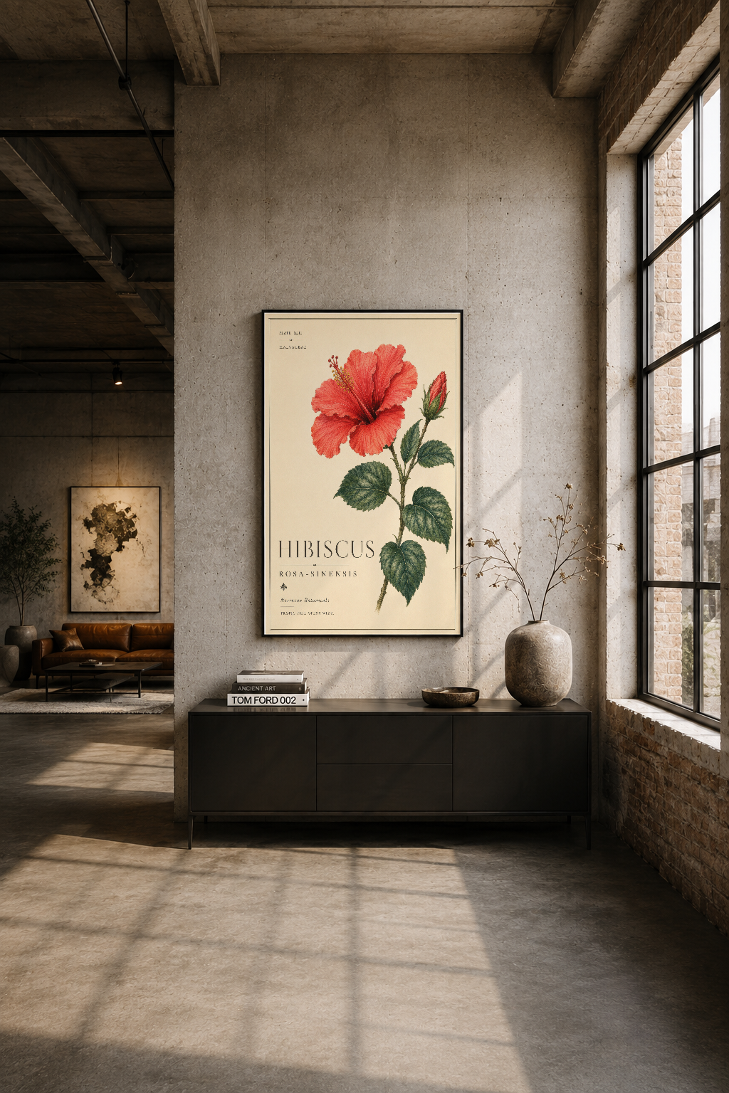 Modern loft oturma alanında siyah çerçeveli hibiskus tablosu, endüstriyel dekor aksanı.