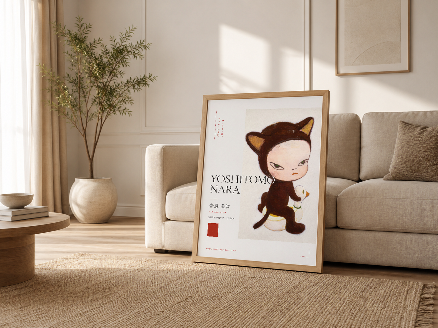 Krem tonlarındaki oturma odasında, ahşap çerçeveli Yoshitomo Nara posteri kanepenin yanında, modern rahat dekorasyonun